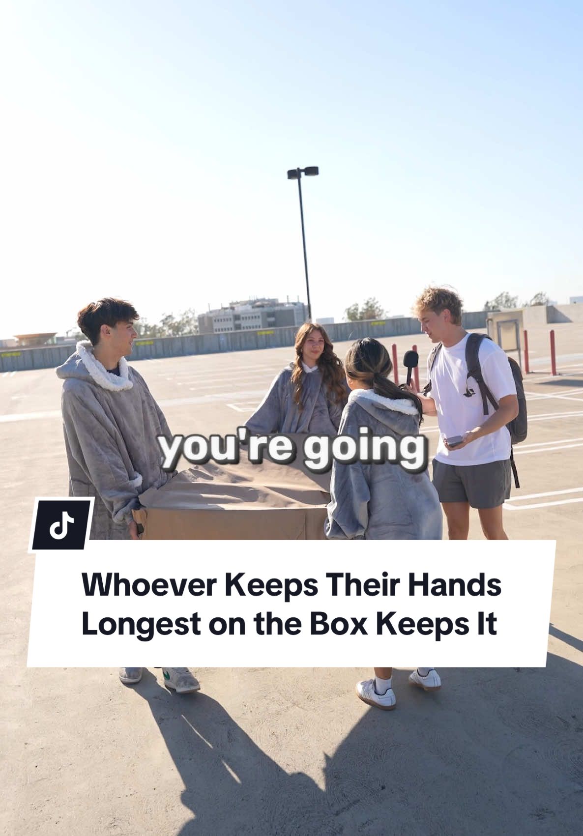 A post by @johnrusanov on TikTok caption: Would you put your hand on a random box for a prize? #manonthestreet #streetinterview 