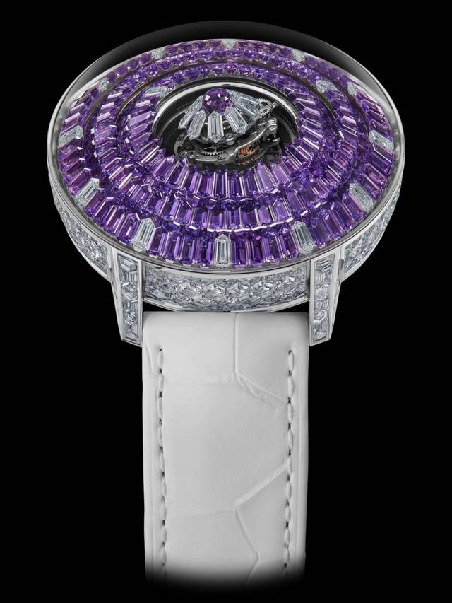 A post by @jacobandco on TikTok caption: This is what happens when fine watchmaking meets fearless gem-setting. The Mystery Tourbillon 44MM dazzles with 260 hexagon-cut white diamonds on the case, a crown of 250 baguette-cut amethysts around the mystery rings, and a triple-axis flying tourbillon glowing from within — set with a Jacob-cut amethyst and nine diamonds. Built to mesmerize. Powered to perform. #JacobAndCo #InspiredByTheImpossible 