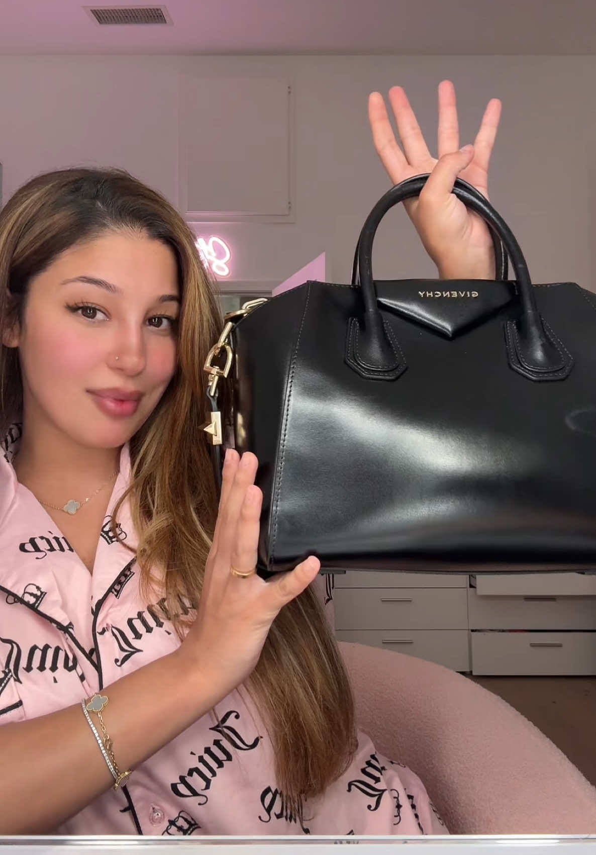 A post by @stunnaababy_ on TikTok caption: What’s in my bag 🖤 @MyLavishCloset #fypシ゚viral 