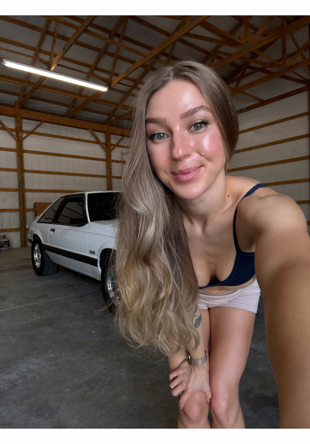 A post by @montanablueee_ on TikTok caption: Post workout! Feeling like Cbum working out next to my Car in the garage! 😋 #cbum #fitness #weightlifting #girlswholift #fyp 