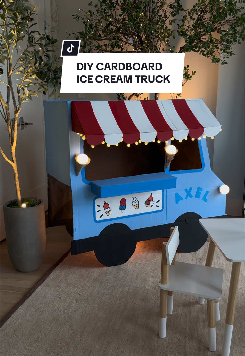 A post by @the_avantgarde on TikTok caption: What happens when I’m given some cardboard and lighting? The most magical ice cream social 🥹💡📦✨  #diy #cardboard #icecream #crafts 