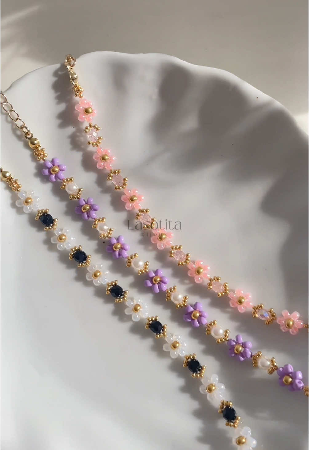 A post by @bijouxlasotita on TikTok caption: Obsessed with these this summer ✨💜 Bijouxlasotita.com 🫶🏻 #handmadejewelry #canadiansmallbusiness #beadedbracelets 