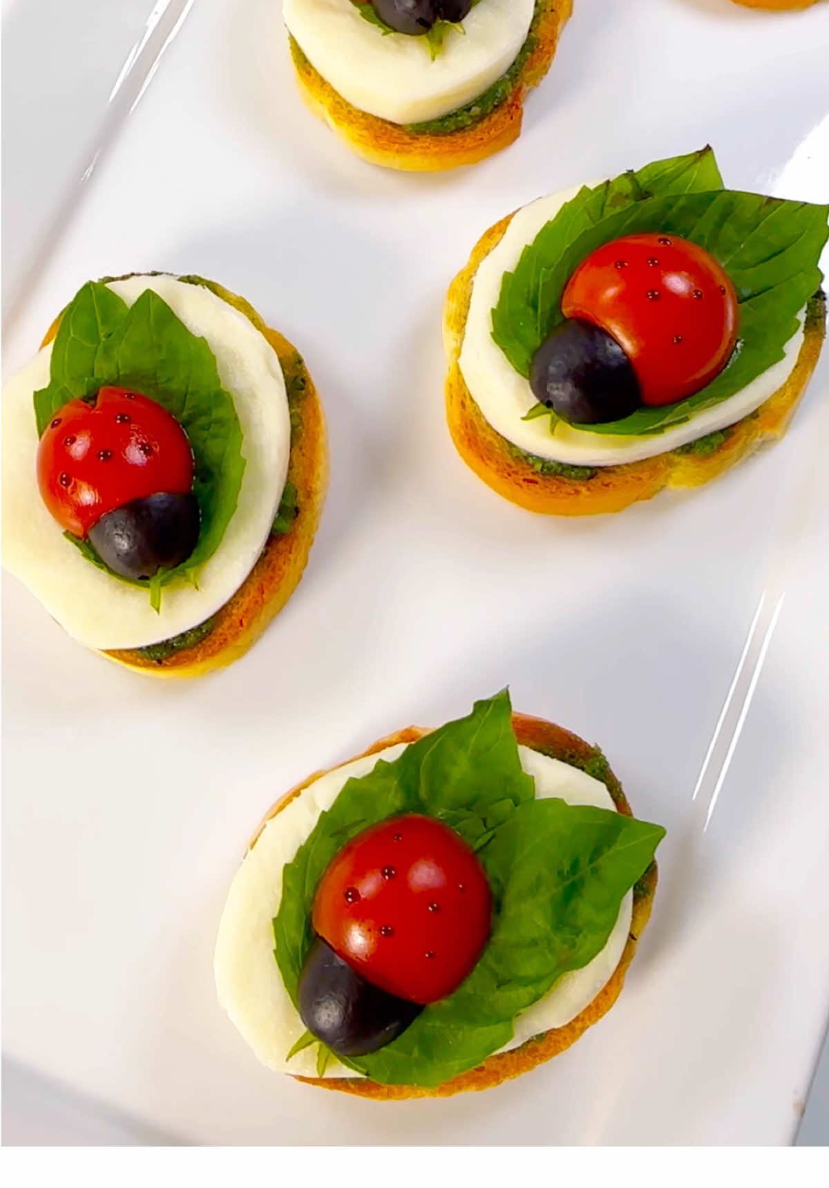 A post by @chefgenevieve on TikTok caption: Ladybug Caprese Bites 🐞 #springrecipes #SummerRecipes #ladybugbites 