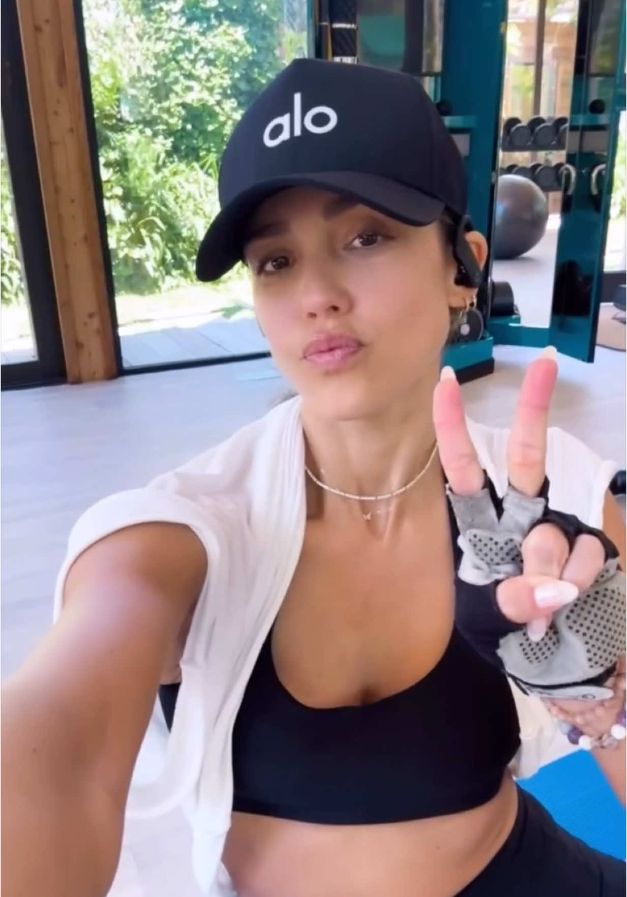 A post by @jessicaalba on TikTok caption: Feeling proud that my #workout clothes got some use this trip 😂 #Fitness #Bike #Weights 