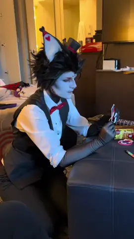 A post by @jijnnicosplay on TikTok caption: #onthisday @a bird and i played an intense game of uno #hazbinhotelcosplay #hazbin #hazbinhoteladam #hazbinhotelhusk 