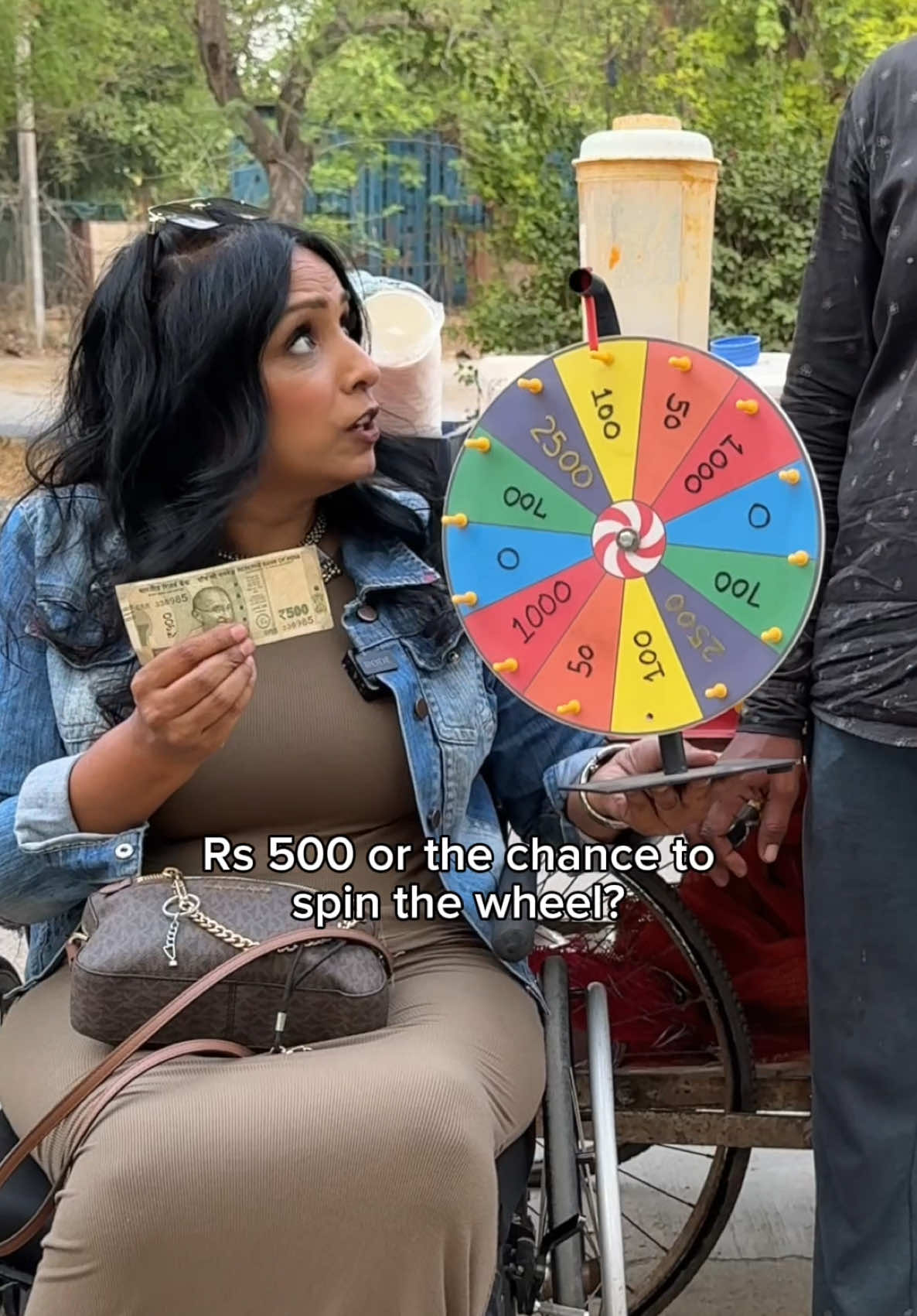A post by @theofficialgeet on TikTok caption: Rs 500 ya wheel ko spin karoge? 🥰 4 mehnati logo ko option diya… dekho unka luck kaisa tha 🔥 Kaisa lagga humara ye latest challenge? Iss situation me aap kya karte? Join Me to Spread Happiness 👉🏼 @theofficialgeet 🥰 . . #theofficialgeet #lovegeet #humanity #randomactsofkindness #surprise #trending #elderly #streetvendor #tiktokpartner 