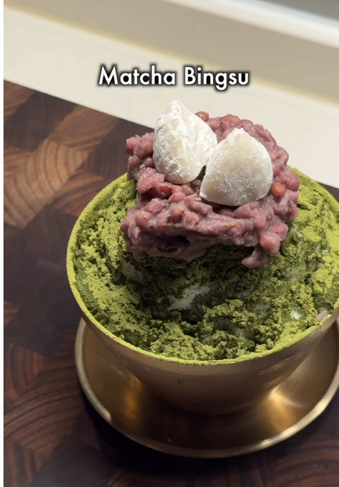 A post by @_cookim_ on TikTok caption: Matcha bingsu at home Recipe 1. Mix milk, water, condensed milk and salt 2. Put it to freezer for 8 hour and grate it using a grater (milk based shaved ice) 3. Mix condensed milk, matcha powder, salt and milk to make matcha syrup 4. Boil red bean for 1 hour and add sugar, salt, butter to make sweet red bean paste 5. Layer shaved ice and matcha syrup in order, then sprinkle a mix of matcha powder and powdered sugar on top. Finish with sweet red bean paste #koreanfood #koreandessert #matcha #bingsu #summer 