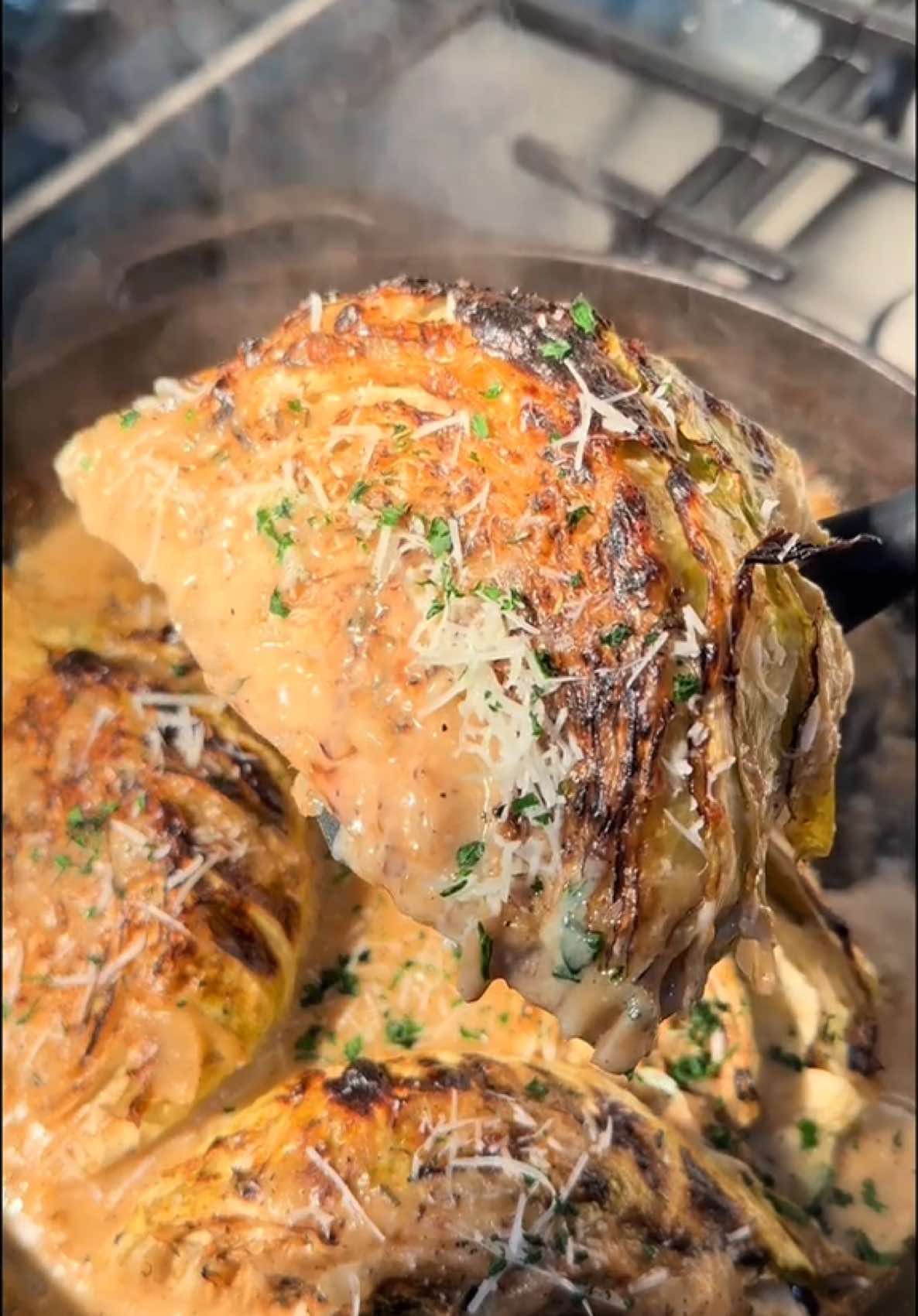 A post by @cookingwithdestiny_ on TikTok caption: Garlic parm melting cabbage 🥬 🤤 this was soooo good! inspo: @boydbrown3  Ingredients: Cabbage Olive oil  Salt Pepper Italian seasoning Cajun seasoning  2 1/2 cups chicken broth 2 tbsp butter 1/2 small onion 2 tbsp minced garlic Cornstarch slur (to thicken sauce if needed) Parsley Cream cheese Grated Parmesan cheese
