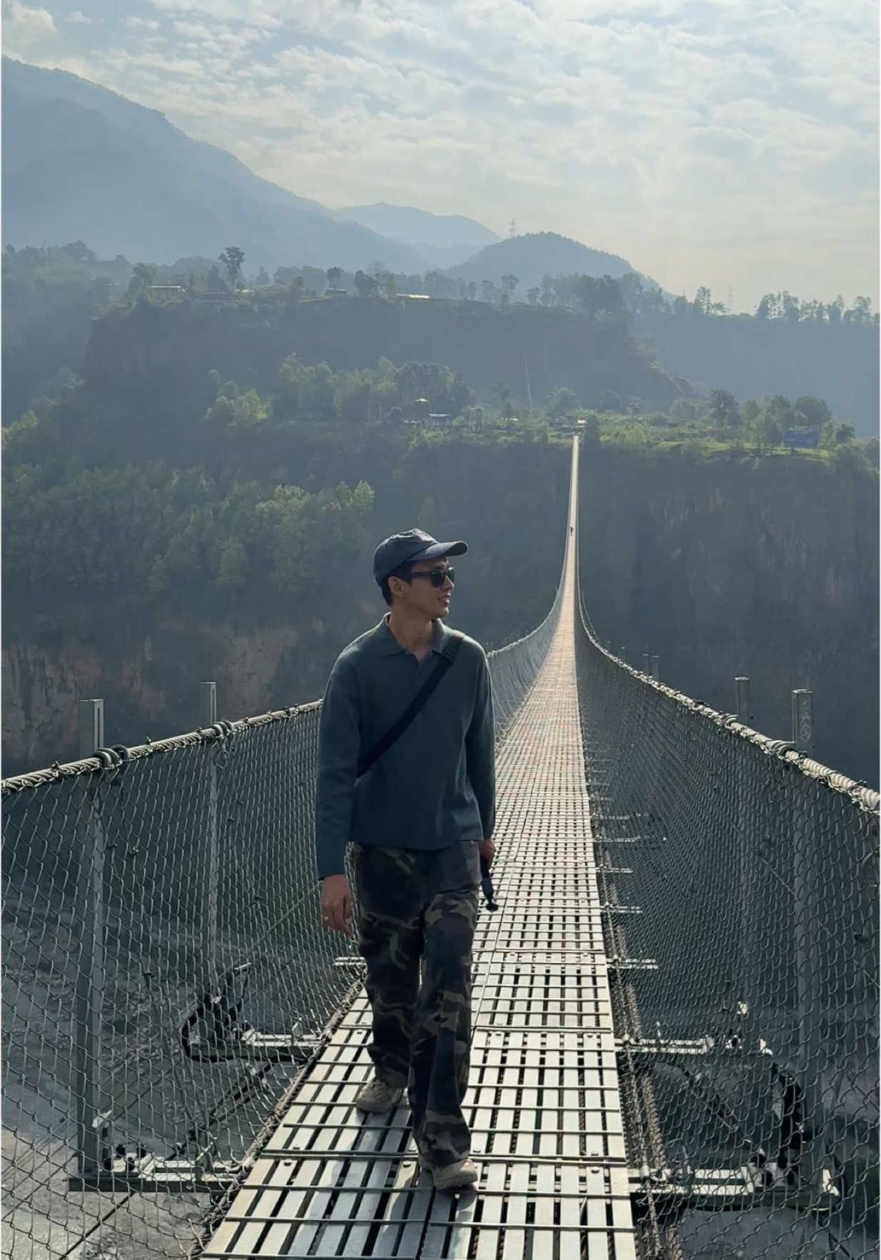 A post by @rickkh on TikTok caption: The long hanging bridge 🇳🇵  #pokhara #nepal #rickkh 