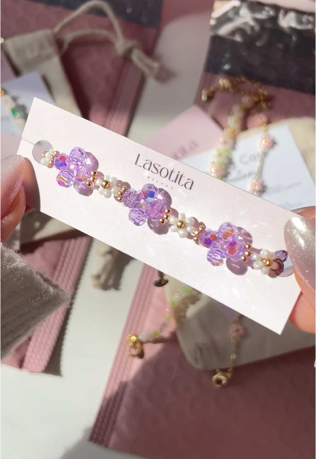 A post by @bijouxlasotita on TikTok caption: Packing some orders 😄🌸✨🩷 #handmadejewelry #canadiansmallbusiness #beadedbracelets #packingorders 