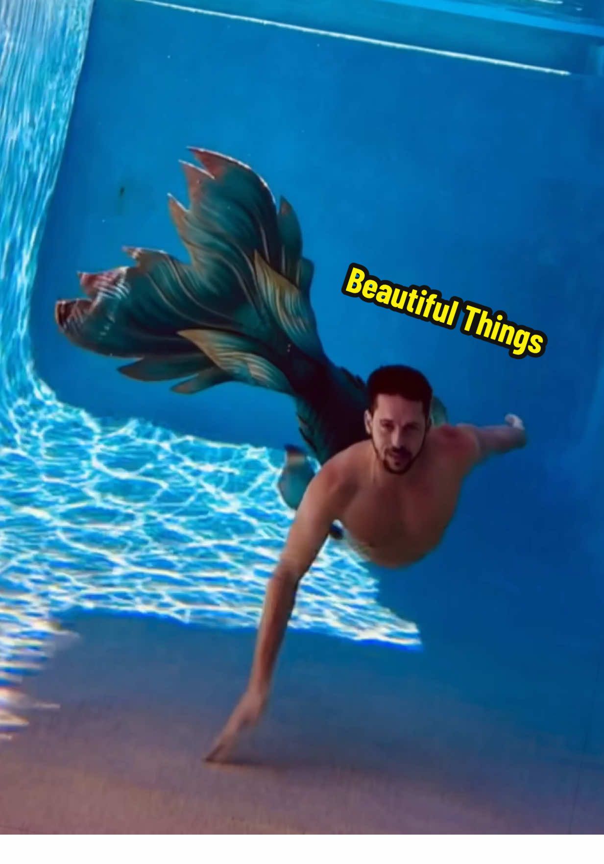 A post by @mermanthommy on TikTok caption: ✨ Chasing beautiful things beneath the surface… ✨ Wearing my tail Solstice by @finfolkproductions — where the magic meets the deep. Every splash, every flip, every frame… crafted for those who believe in the beauty of becoming. 🌊🐚 🎥 Fast cuts, full feels — turn up the sound and dive in. 🧜‍♂️ Drop a 🌞 if you believe in chasing what sets your soul on fire. Follow for more mermaid magic, behind-the-scenes content, and ocean dreams come to life. 💚💛@Finfolk Productions 