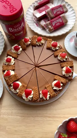 A post by @kookmutsjes on TikTok caption: NO BAKE BISCOFF PIE #food #recipe #pie #nobake #biscoff #cream #tasty #fy #fyp COOKIE DOUGH 175 g Biscoff cookies 90 g unsalted butter CREAM  200 g white chocolate 250 g mascarpone 100 g Biscoff cookies TOPPING 125 g Biscoff spread GARNISH whipped cream strawberries Instructions: Melt the butter in a saucepan over low heat. Finely crush the Biscoff cookies using a food processor. In a bowl, combine the crushed cookies with the melted butter. Line the bottom of a springform pan with baking paper. Spread the cookie mixture evenly across the bottom and press it down firmly with the back of a spoon, making sure to press up the sides as well. Chill briefly in the fridge. Melt the white chocolate using a double boiler (bain-marie). Let it cool slightly. In a bowl, combine the cooled chocolate with the mascarpone and mix for 1 minute. Roughly crumble the  Biscoff cookies and fold them into the cream. Spread the cream mixture evenly over the cookie base. Gently heat the Biscoff spread in a saucepan over low heat while stirring, until it becomes liquid. This happens quickly, so stay close. Let it cool briefly. Pour the liquid Biscoff spread evenly over the cream layer. Place the cake in the fridge to set. Slice the dessert. Garnish each slice with a dollop of whipped cream and a fresh strawberry.