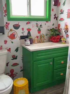 A post by @thriftyweenqueen on TikTok caption: Painting my bathroom cabinets green! 