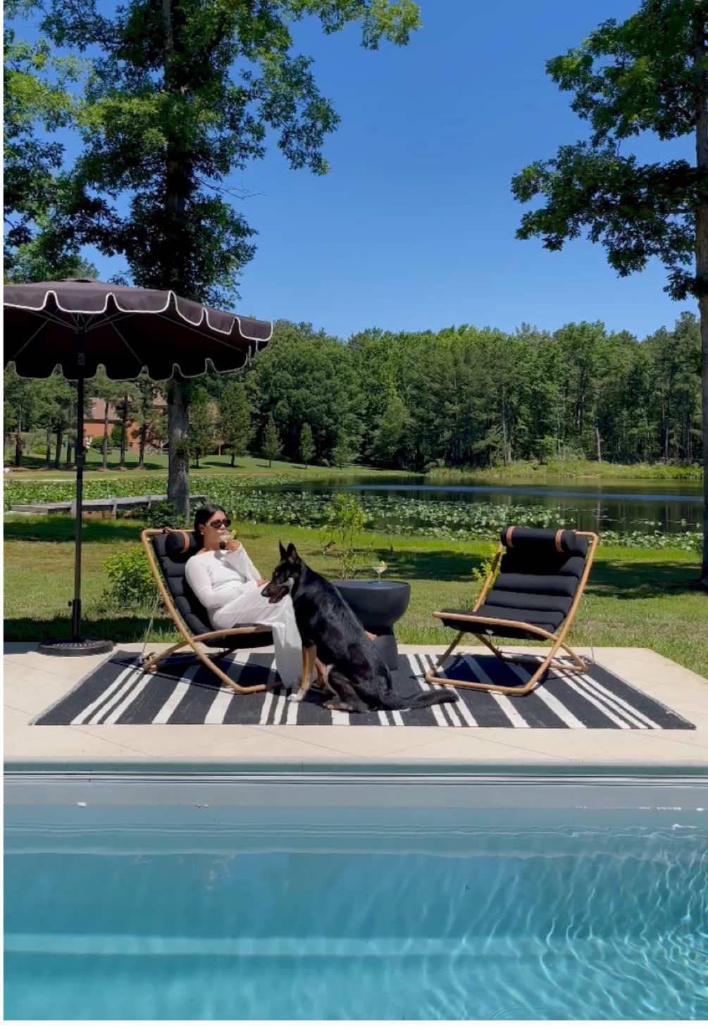 A post by @roveconcepts on TikTok caption: Poolside moments featuring Jericho Sling Chair and Maria Side Table.  Video by @TheHedgedHome #RefinedLuxuryLiving #RoveConcepts #Fyp #OutdoorFurniture 