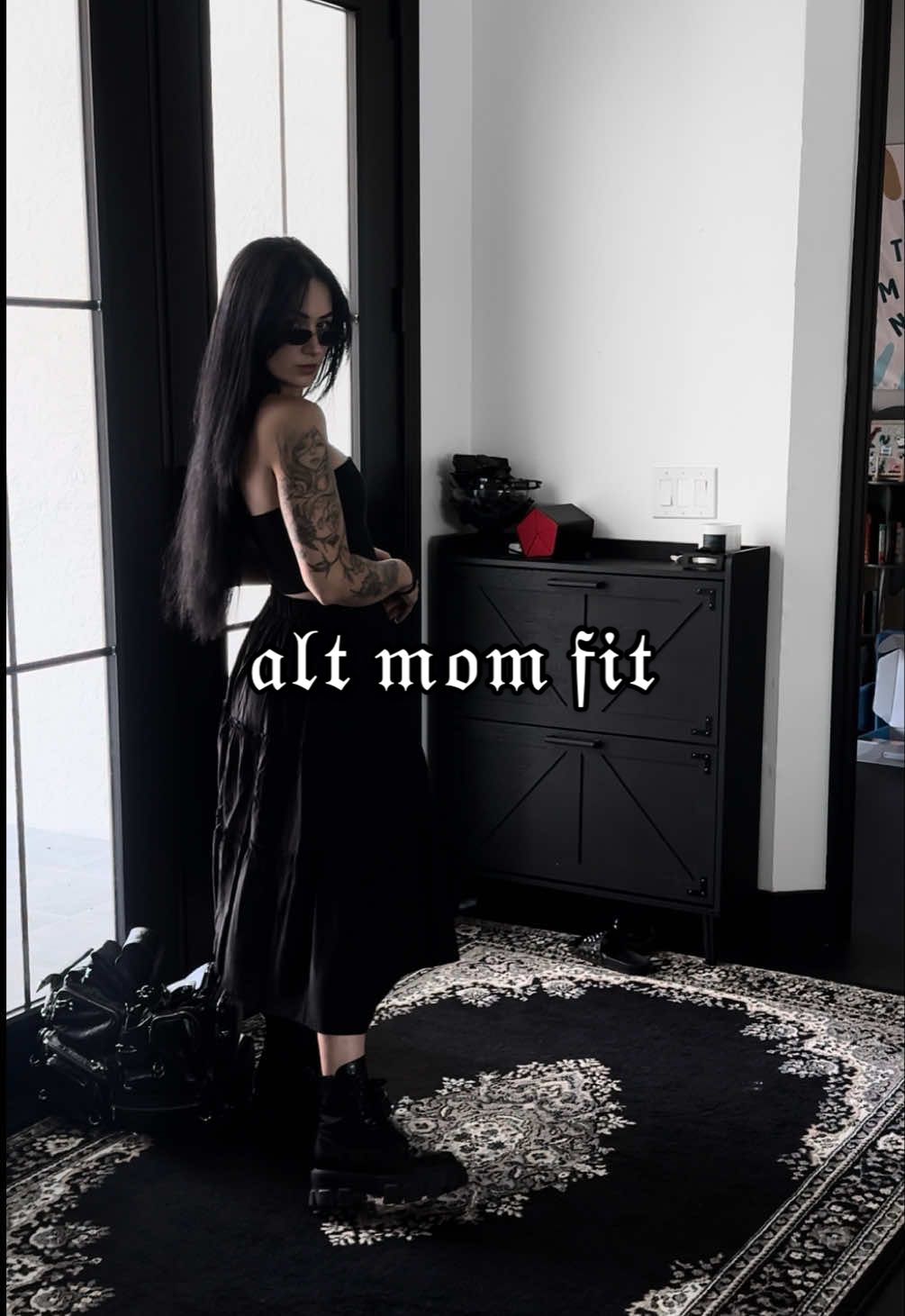 A post by @evdreadful on TikTok caption: another day 𝔞𝔫𝔬𝔱𝔥𝔢𝔯 𝔞𝔩𝔩 𝔟𝔩𝔞𝔠𝑘 𝔣𝔦𝔱 🤘🏼🖤 ##ootd#alt #grwm #gothmom #allblack #styling #aesthetic #wuhluhwuh #twinmom