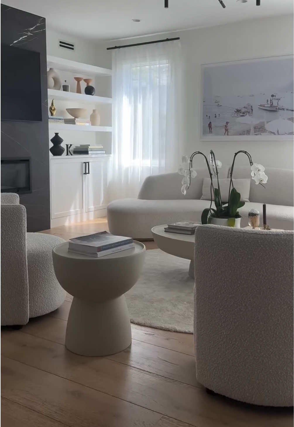 A post by @roveconcepts on TikTok caption: From basic to breathtaking. Featured furniture: Reya Curved Sectional, Nova Lounge Chair, Maria Coffee and Side Tables Video by @kurb.interiors #RefinedLuxuryLiving #RoveConcepts #Fyp 