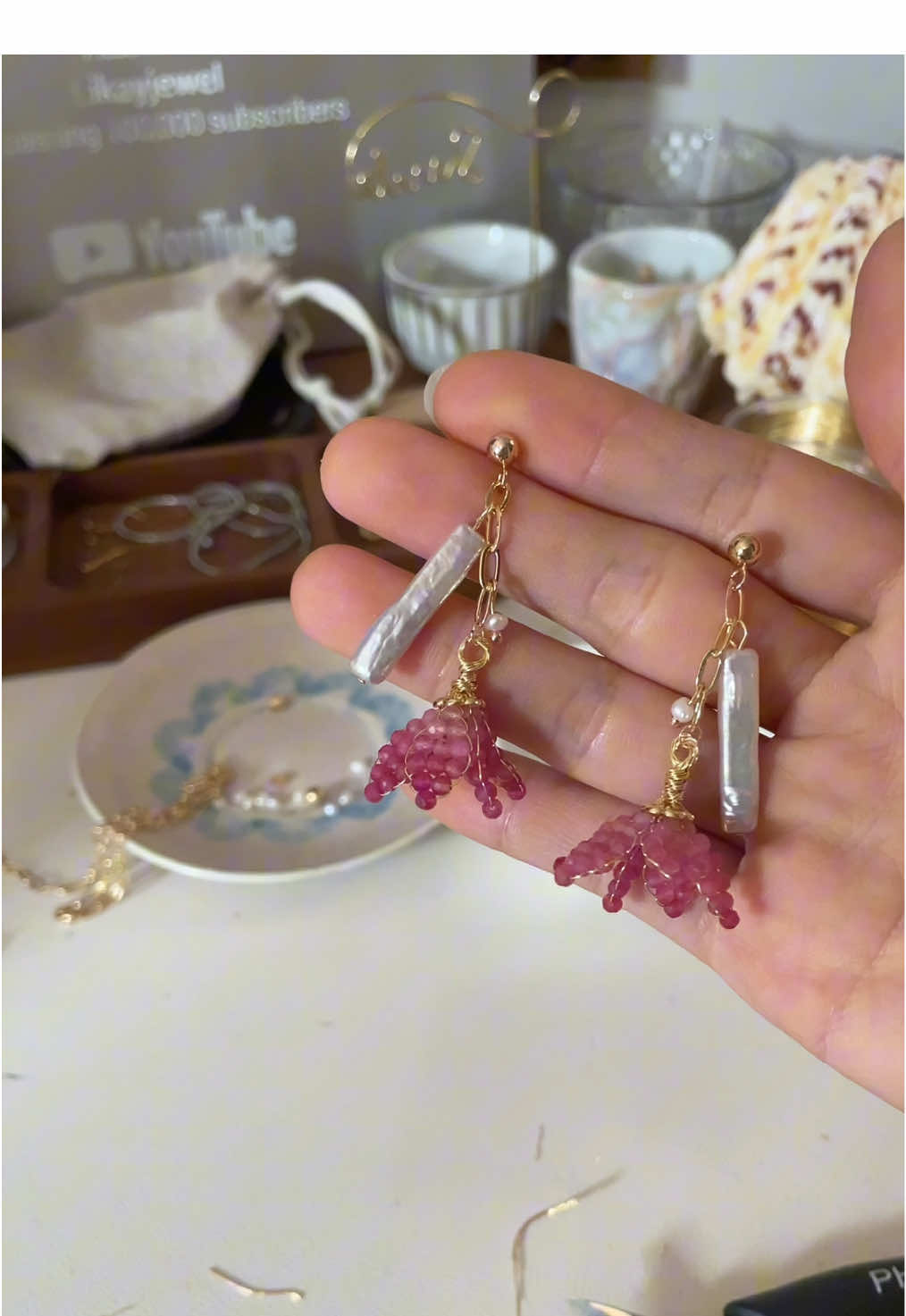 A post by @likayjewel_diylilylin on TikTok caption: Pink summer flowers earrings 🌷🌸✨💕#handmadejewelry #tutorial #wirewrapping #earrings #dropearrings #handmadeearrings #summerjewelry #jewellery #foru #earringslovers #earringcollection #flowerearrings 
