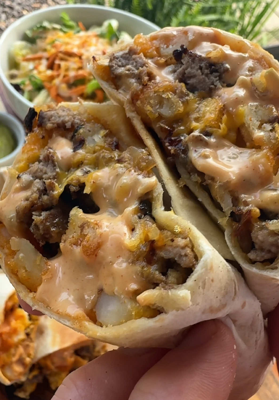 A post by @cookinginthemidwest on TikTok caption: Animal Style Cheeseburger Burritos are easy to make and won’t disappoint!  INGREDIENTS  1 onion, chopped 2 tbsp butter  Mustard  1 lb ground beef (4 patties)  McCormick Hamburger Seasoning  Burrito size tortillas  Crinkle cut fries  American Cheese  SAUCE 1/2 cup mayo 1/4 cup ketchup 1 tbsp mustard 2 tbsp sweet relish 1 tbsp vinegar 1/4 tsp garlic powder and smoked paprika  INSTRUCTIONS  Make the homemade animal style sauce by combining ketchup, mayo, mustard, sweet relish, vinegar, garlic powder, and smoked paprika. Once the sauce is made store it in the refrigerator until you are ready to build the burritos!  Cook the bag of fries in an air fryer or oven following the directions on the package.  Heat a griddle over medium high heat and add the chopped onions to the griddle with butter. Stir well.  Next, add the burger patties to the griddle. Use a burger smasher to smash the burgers into the griddle. Cover the patties in yellow mustard and season with Hamburger seasoning. Once a nice crust has formed flip the burgers over and let finish cooking. Chop the burgers into smaller pieces.  Lay out a large burrito size tortilla. Add the homemade sauce, a handful of crispy fries, a slice of American cheese, the cooked burger, grilled onions, another slice of cheese, and more of the homemade sauce. Carefully roll up the burrito and place on the griddle seam side down. Cook on medium heat until both sides are golden brown. Enjoy!  #easyrecipes #griddlerecipes #burrito #cheeseburger #animalstyle 