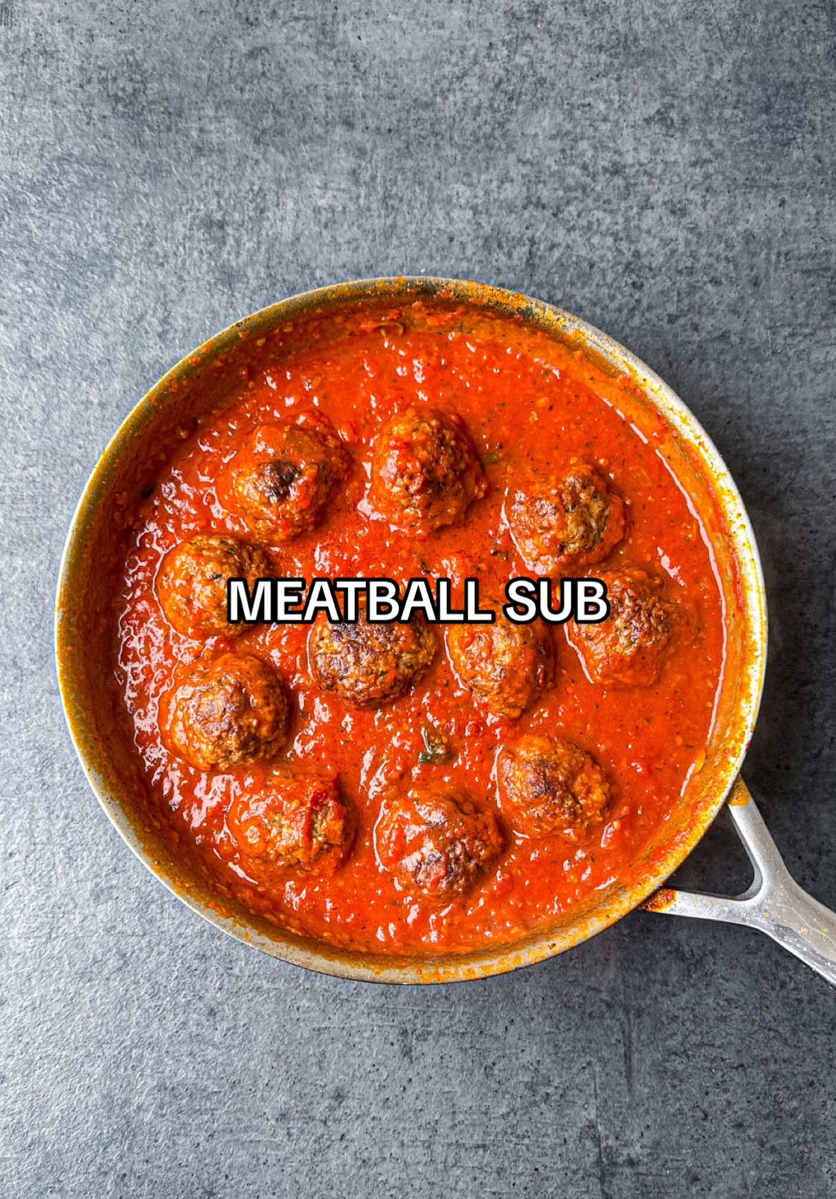 A post by @samseats on TikTok caption: Meatball Sub 🥖 Full recipe now up on Substack - link in bio! 🔥❤️ #meatballs #sandwich #datenight #comfortfood #recipe #asmr 