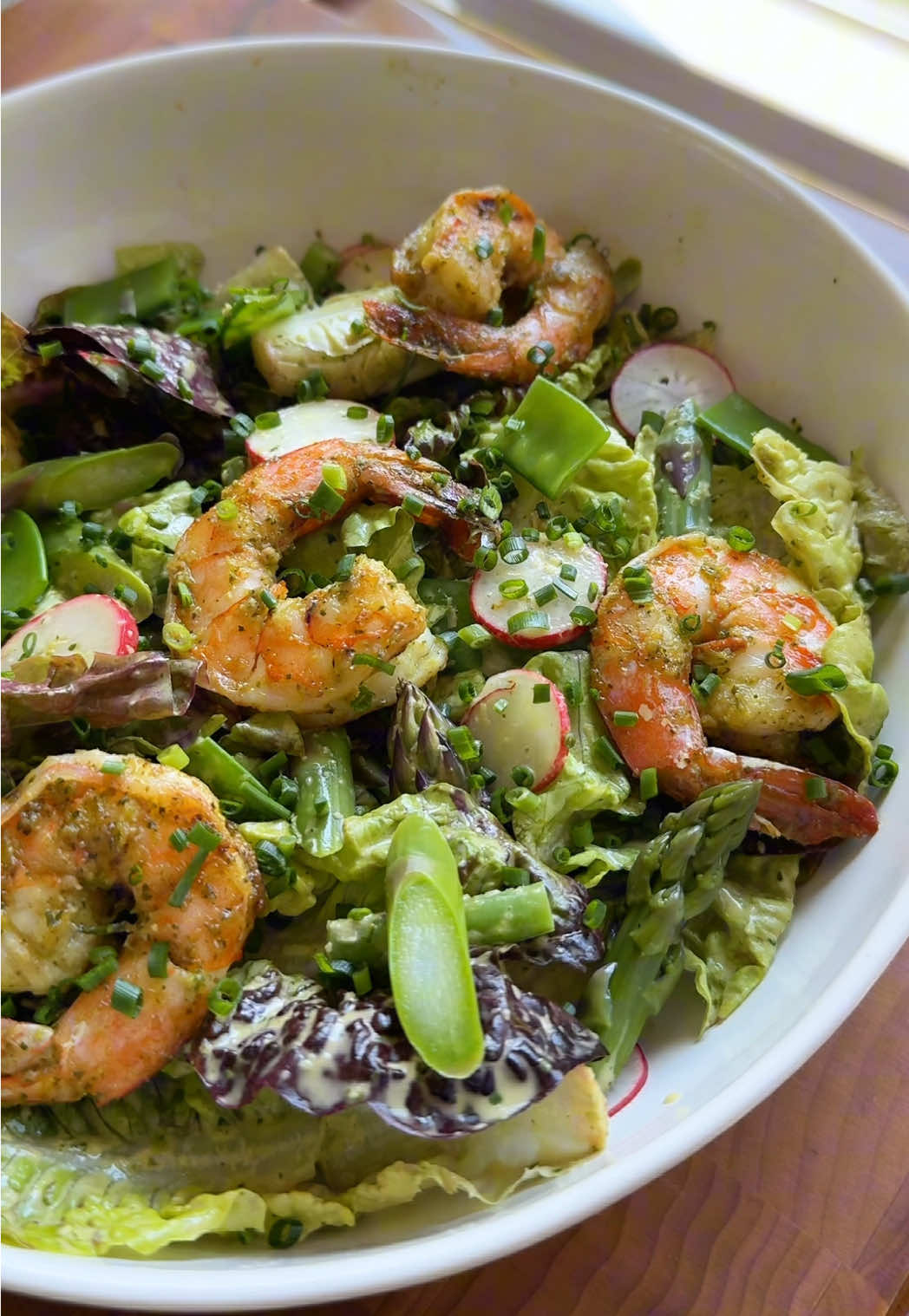 A post by @kristenfaith_eats on TikTok caption: Spring Salad with a green garlic sesame dressing  #farmersmarketfinds #springsalad #asparagus #shrimprecipe #saladrecipe #EasyRecipe #yum #fyp #springrecipe 