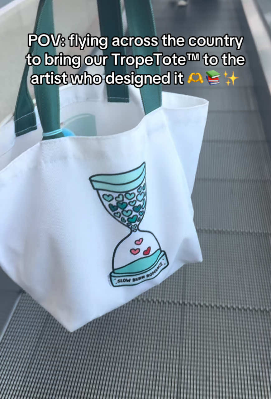A post by @thriftbooks on TikTok caption: Even when one TropeTote™ is over, we love our artists. See how we brought our best selling Slow Burn TropeTote™ to the original artist @mysecretcopy in LA. Get ready for our next launch (coming sometime in June). #thriftbooks #readersgonnaread #readerlife #BookTok #totebag #tropetote #artisttok   