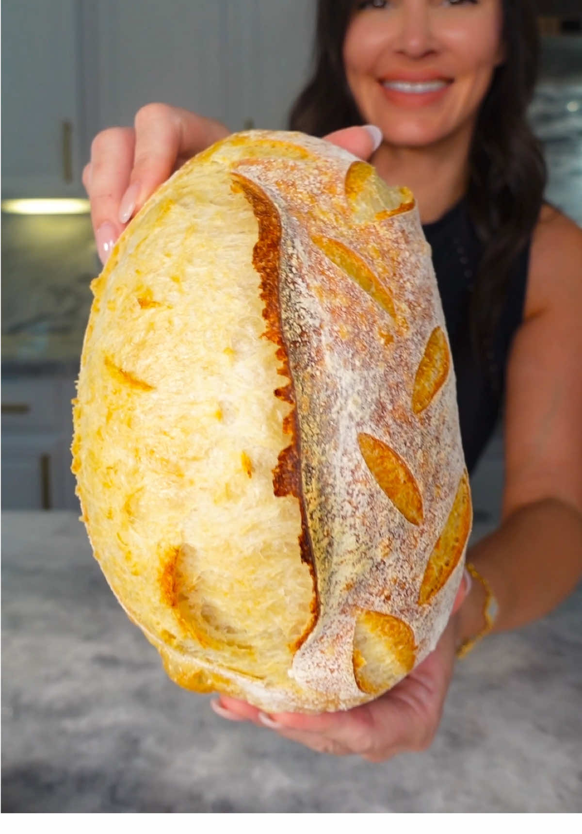 A post by @chefgenevieve on TikTok caption: Homemade Sourdough Bread Recipe and Instructions #sourdough #sourdoughbread #sourdoughrecipe #baking  Ingredients: 80g sourdough starter  250g purified water 350g bread flour 10g salt Directions: After feeding your starter (40g starter + 40g purified water + 40g flour) and it has doubled in size, pour 80g into a bowl. Add 250g of purified water, and mix together. Next, add 350g of bread flour. Mix together, making sure all the flower is incorporated. Cover the dough and measure out 10g of salt. After 30 minutes have passed add your salt and begin shaping into a ball. This process should take less than 1 minute. Cover.  45 minutes after your shaping, stretch and fold you dough. With damp hands, pull the dough up from the side and fold over. Rotate the bowl and repeat 2 more times. Cover. After another 45 minutes, I like to do coil folds.  With damp hands, pull the dough up from the center and allow the bottom to fold under itself.. rotate the bowl and repeat this two more times.  After 45 minutes perform coil folds one more time. Cover for the bulk rise (about 4 hours or until dough has doubled in size) Lightly flour your surface area and flip your bowl over releasing the dough.  Fold the right and left side in, then the top and bottom in, then roll tightly up into a burrito shape (this method is best if using an oval basket) If using a round basket, a push and pull method to shape your dough is preferred.  Add some flour to a lined banneton basket then add your dough seems side up. Cover and refrigerate for 12 hours. After twelve hours (the cold ferment) preheat your Dutch oven pot in a 450°F oven. Flip banneton over on the parchment paper. Brush any remaining flower evenly then makes your scores.  To your preheated Dutch oven pot, add your dough with parchment paper, cover with the lid and place in the oven on the middle rack. Turn the heat down to 400° and bake for 20 minutes. After 20 minutes, remove the lid and bake for an additional 20 minutes. Allow to rest at room temperature for one hour before slicing. 