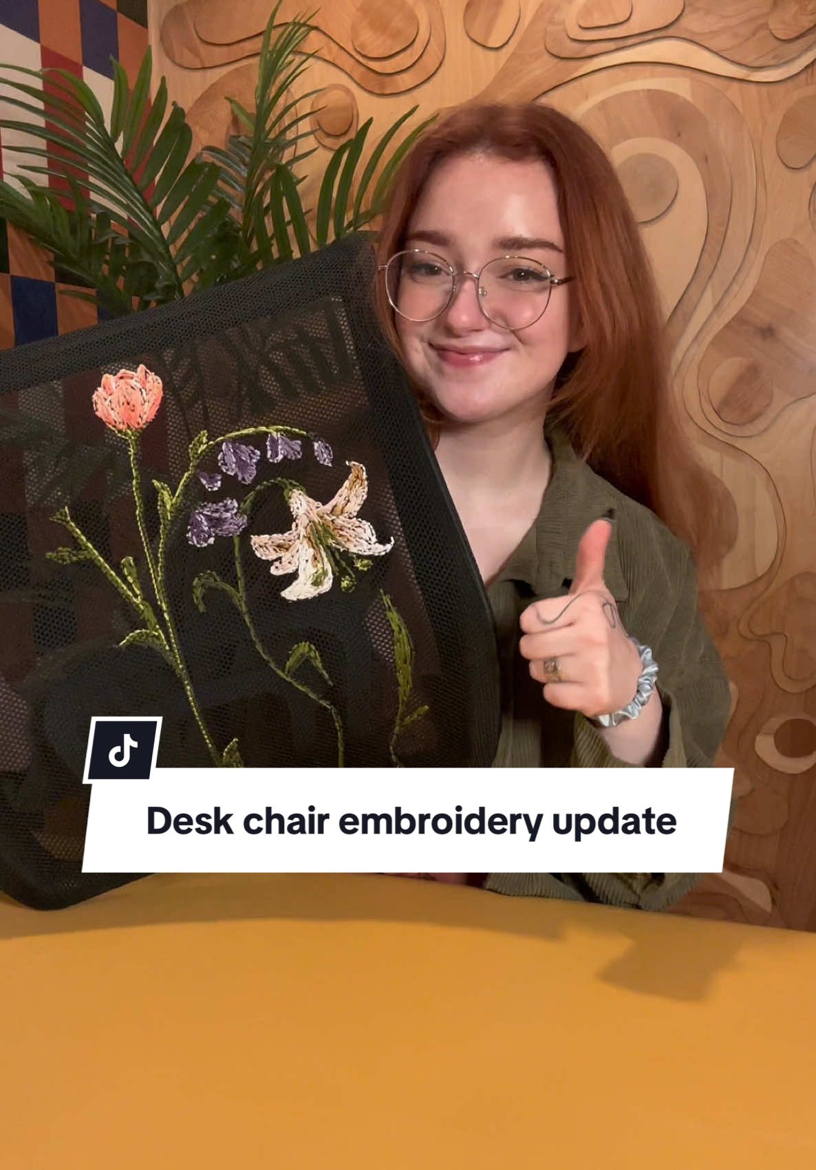 A post by @emilyrayna on TikTok caption: I think everyone should have a floral desk chair now honestly #diyproject #embroidery #upcycle #wfh #diyhomedecor 
