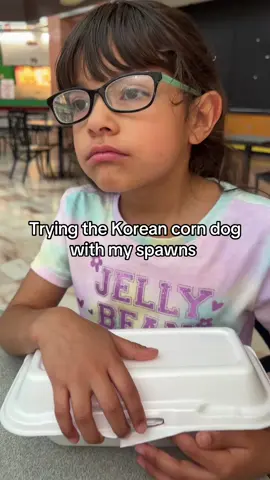 A post by @arimonika on TikTok caption: TRY TO KOREAN CORN DOG WITH OUR SMALL FAMILY .👩🏽‍🍳🩴 Can you tell MELANIE was upset from the beggining because her sister got first bite ? 😂 #imyourmomnow #familyvlog #koreancorndog #koreancorndogtastetest #koreancorndogmukbang #sahm #familyof3 #potatodog #momanddaughter 