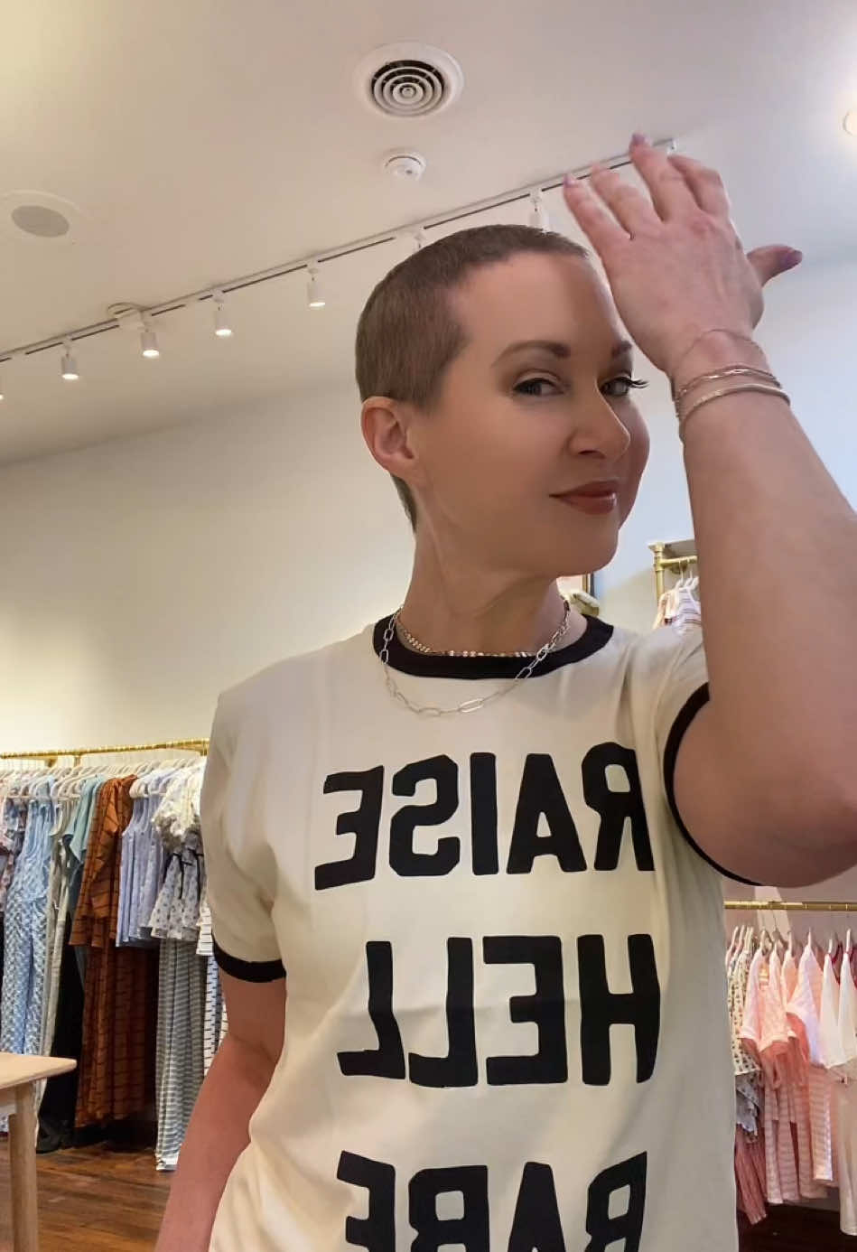 A post by @rivervalleydesigns on TikTok caption: Today is National Cancer Survivors Day, so I celebrated by playing dress up in some of the new clothes that are ready for opening day (TBA), haircut by my med oncologist. 😬 One becomes a survivor on the day they are diagnosed. Wherever you are on the path, I’m sending all my strength + healing & thriving vibes. Keep your chin up. I love you! #wheelingwv #boutique #cancersurvivor #breastcancer #smallbusiness 