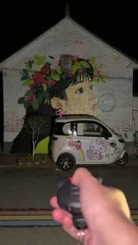 A post by @ellaonwheels_0 on TikTok caption: 👧🏻The girl painted on the wall is so beautiful that I parked my car here for camping today.🏕️It's raining today. I'm going to eat some instant noodles and spicy strips and continue to listen to the rain.🌧️ #tricycle #minicar #campinglife #limousine #Outdoor #fyp #electriccar #relax #camping #rain 