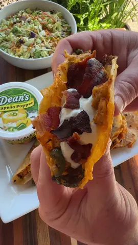 A post by @cookinginthemidwest on TikTok caption: #sponsored Jalapeño Popper Chicken Tacos are easy to make and perfect for Summer! These tacos aren’t complete without Dean’s Jalapeño Popper Dip! @Dean’s Dip  INGREDIENTS 6 pieces of bacon  1 lb chicken breast, cut into cubes Oil 1/2 tsp each salt and pepper 1 tsp each garlic powder, onion powder, and smoked paprika 2-3 jalapeños, sliced  White corn tortillas  Shredded cheddar cheese Dean’s Jalapeño Popper Dip  INSTRUCTIONS  Cut 1 lb of chicken breast into small cubes. Heat a griddle over medium-high heat. Add the bacon to one side of the griddle. Once the bacon is fully cooked remove it from the griddle and set aside on some paper towels to drain the grease.  Add the chicken to the other side of the griddle with some oil. Season with salt, pepper, garlic powder, onion powder, and smoked paprika. Stir well.  Add the sliced jalapeños to the griddle. Stir them into the cooked chicken.  Add more oil to the griddle and lay out the corn tortillas. Flip the tortillas over once browned. Add shredded cheddar cheese, the chicken, and jalapeños. Fold tacos over and cook them on both sides until golden brown.  Top the tacos with Dean’s Jalapeño Popper Dip and crumbled bacon. Enjoy!  #easyrecipes #griddlerecipes #tacos #jalapenopopperdip #chickentacos 
