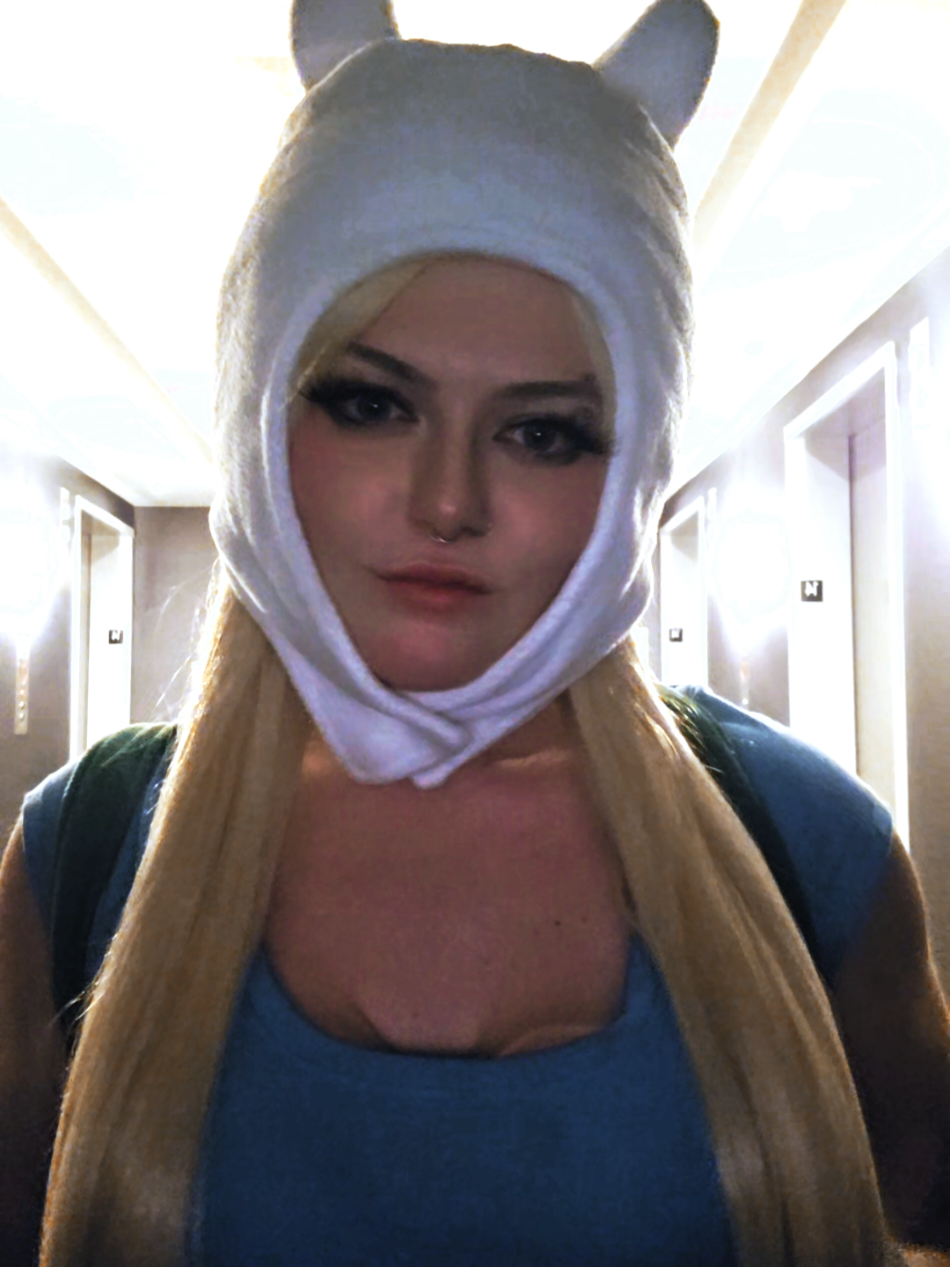 A post by @ on TikTok caption: #adventuretime #adventuretimecosplay #finnthehumancosplay #jakethedog #cosplay #lipsync #momocon 