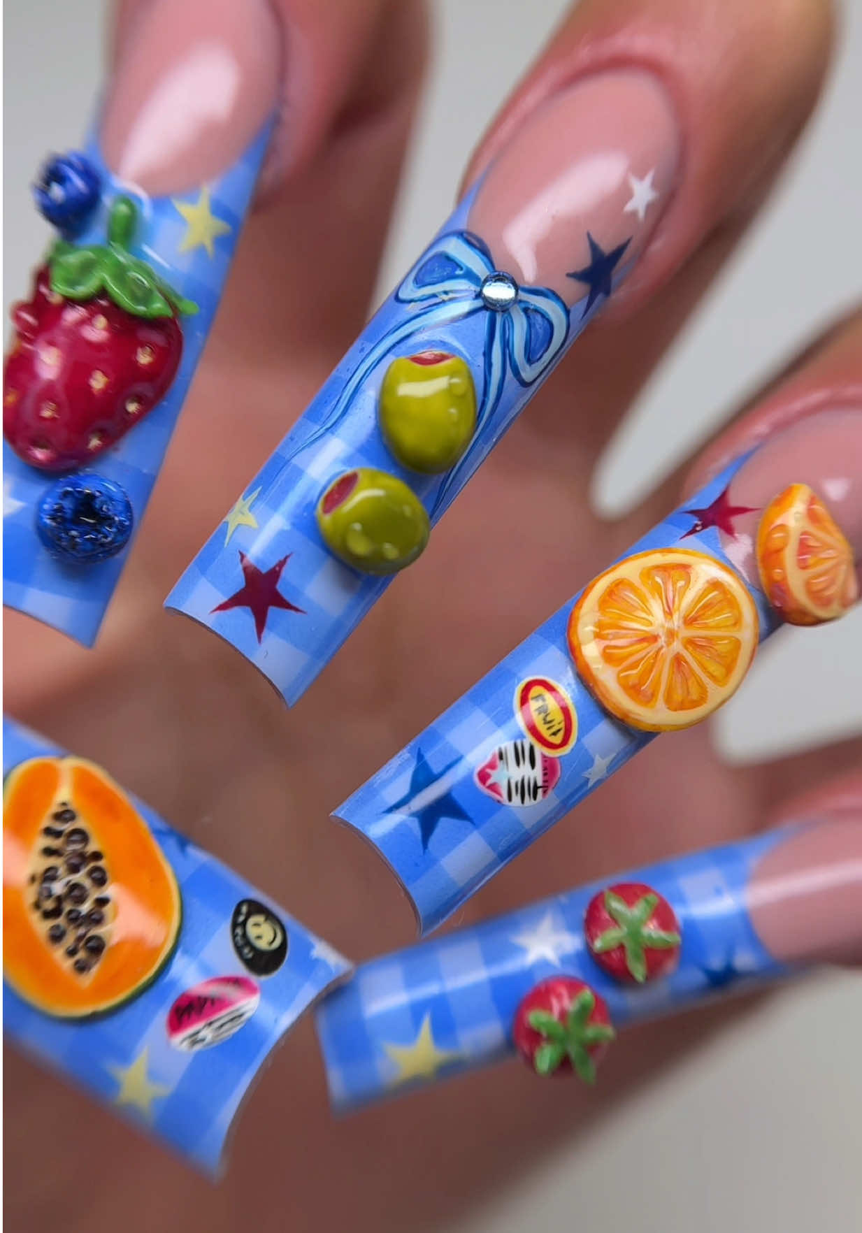 A post by @sulysnailography on TikTok caption: Picnic nails 🍅🫐  #plaidnails #airbrushnails #bluenails #picnicnails #fyp #nailtok #gelxnails #xlnails #fruitnails #3dnailart #strawberrynails #olivenails #summernails 