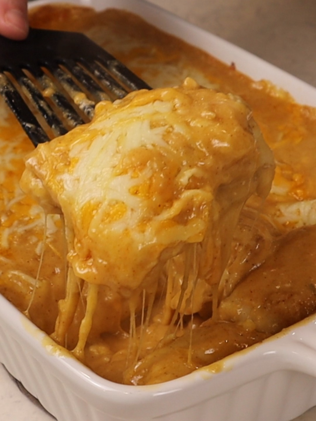 A post by @dollartreedinners on TikTok caption: Cheesy White Chicken Enchiladas (Original Recipe From @tori_and_nessa) This was the clear winner when I asked which recipe you wanted to see first, and it did not disappoint. Creamy, cheesy, comforting, and surprisingly simple. Ingredients You’ll Need (Total Items to Purchase): • 2 boneless, skinless chicken breasts – approx. $3.00 • 1 carton chicken broth (32 oz) – approx. $1.50 • 1 packet taco or chili seasoning – approx. $0.50 • 1 stick butter or margarine – approx. $1.50 • All-purpose flour – approx. $2.00 (or from your pantry) • 2 bags shredded cheese (16 oz total) – approx. $6.00 • 1 block cream cheese (8 oz) – approx. $1.50 • 1 small can or jar of jalapeños (optional) – approx. $0.75 • 1 tub sour cream – approx. $1.50 • 1 package flour tortillas (8–10 count) – approx. $2.00 Total cost: around $20.25 (feeds 4 to 6) Prices will vary based on brand, store, and location. Instructions 1. Cook the Chicken from Frozen: Place frozen chicken breasts in a pot. Add broth until it comes halfway up the chicken. Season with salt, pepper, garlic powder, onion powder, and paprika. Bring to a boil, then cover and simmer 20 minutes. Ensure chicken reaches 165°F internally, then shred or dice. 2. Make the Cheese Sauce: Melt butter in a saucepan. Whisk in flour and taco seasoning, cook 1–2 minutes. Slowly whisk in broth until thickened. Reduce heat, stir in cheese until melted, then whisk in sour cream. Add more broth if too thick. 3. Make the Filling: Combine shredded chicken, softened cream cheese, taco seasoning, shredded cheese, and jalapeños (if using) until smooth. 4. Assemble: Divide filling between 8 tortillas. Roll tightly and set aside. Spread a layer of cheese sauce in a greased 9x13 baking dish. Place rolled tortillas seam-side down. Top with remaining sauce and extra cheese. 5. Bake: Bake at 400°F for 20–25 minutes until bubbly and golden. Let cool a few minutes before serving. Tips & Substitutions You can use rotisserie chicken to save time. Add canned green chiles or sautéed onions to the filling for extra flavor. For a milder sauce, use less taco seasoning and opt for Monterey Jack cheese. This freezes well—assemble, cover, and freeze before baking. Add 10–15 minutes to bake time if cooking from frozen. Michael took one bite and immediately asked if I wrote it down—so this is me making sure I don’t forget. It’s definitely getting made again. #enchiladas #whitechickenenchiladas #budgetmeals #cheeselover #comfortfood #easyweeknightdinner #familydinner #grocerybudget #homemadegoodness #stretchyourbudget #feedthefam #simplemeals #under25dinner