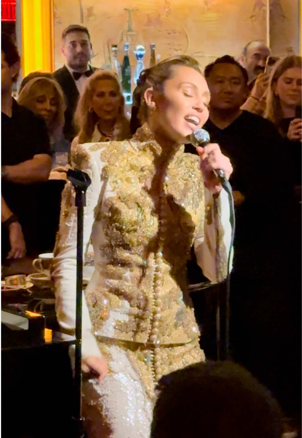 A post by @mileycyrus on TikTok caption: Bemelmans? Belemans? There was some confusion on the pronunciation tonight-but the one thing I'm sure of is performing at the iconic Carlyle Hotel was an absolute honor. A beautiful room, that holds so much history in such a tight space. Whatever you wanna call it, tonight was magical at... Bellinmans? Love you  #MileyCyrusSomethingBeautiful 