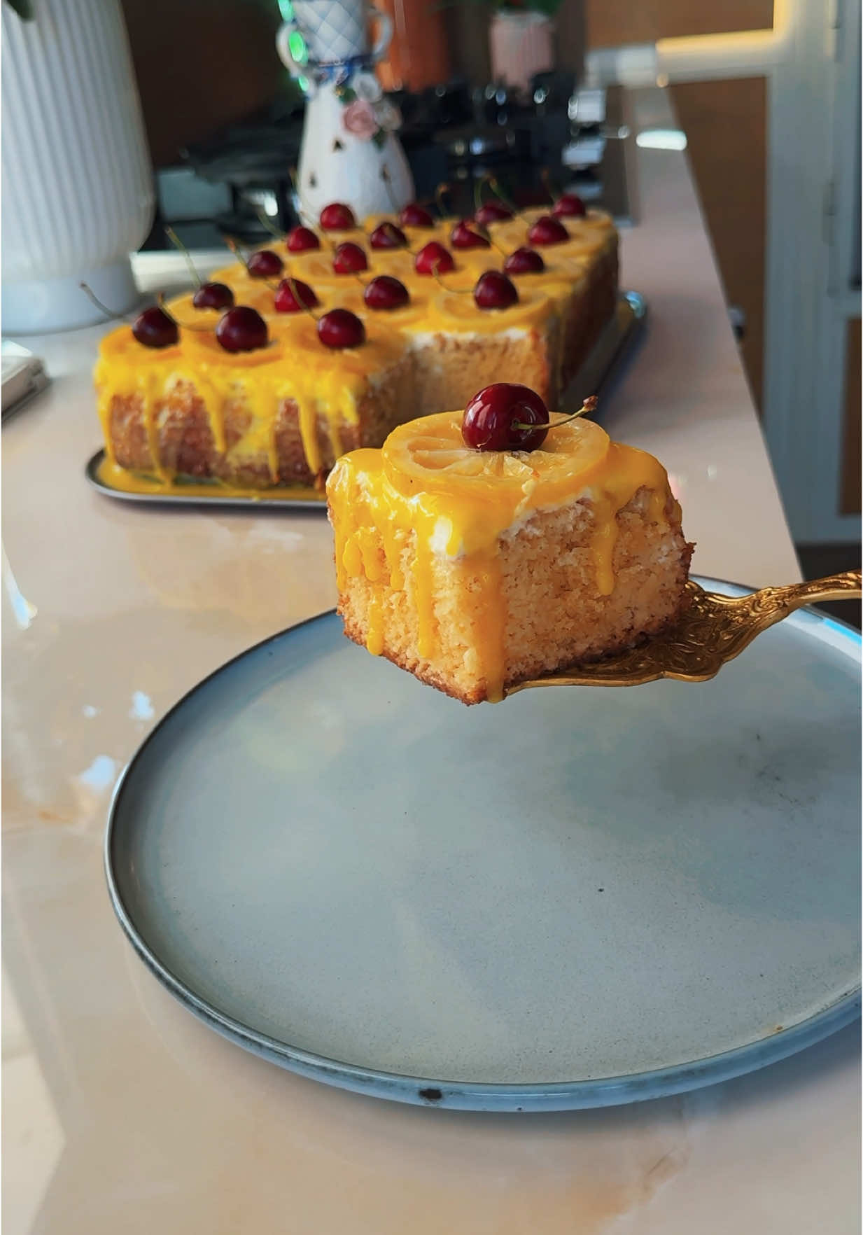 A post by @abir.sag on TikTok caption: Lemon trelece cake 🍋 For the cake :  4 eggs (room temperature)  1 cup sugar  1 tbsp vanilla  1/2 cup milk  2/3 cup oil  1 and 1/2 cup flour  1 tbsp baking powder  Pinch of salt  2 tbsp lemon zest  For the sugar lemon syrup:  2 sliced lemons  1 cup sugar  1&1/2 cup water  For the milk mixture:  1 & 1/2 cup milk  1/2 cup condensed milk  Sugar lemon syrup  For the lemon glaze:  1& cup powdered sugar  1/4 cup melted butter  3 tbsp milk #abirzkitchen #tiktokcookbook 