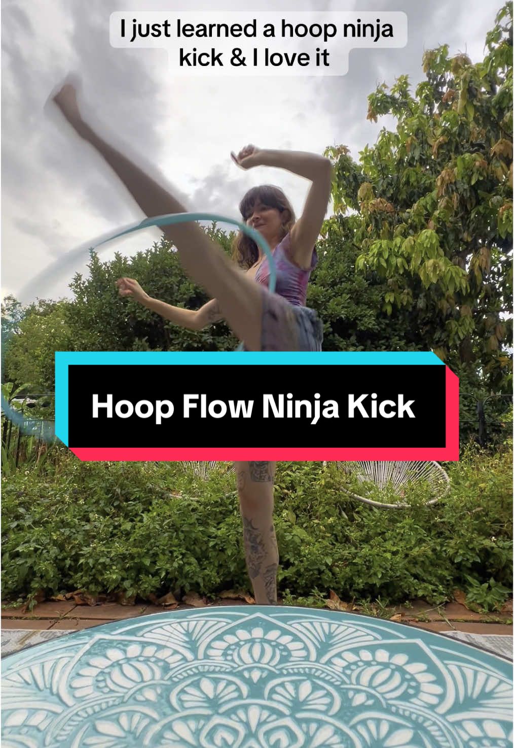A post by @queerbassqueen on TikTok caption: I’ve been wanting to learn this hoop move for a while and I finally got it down!! (I’m pretty sure its called a ninja kick but pls feel free to correct me) #hoopflow #flowarts #edmcommunity #raver #hooper 