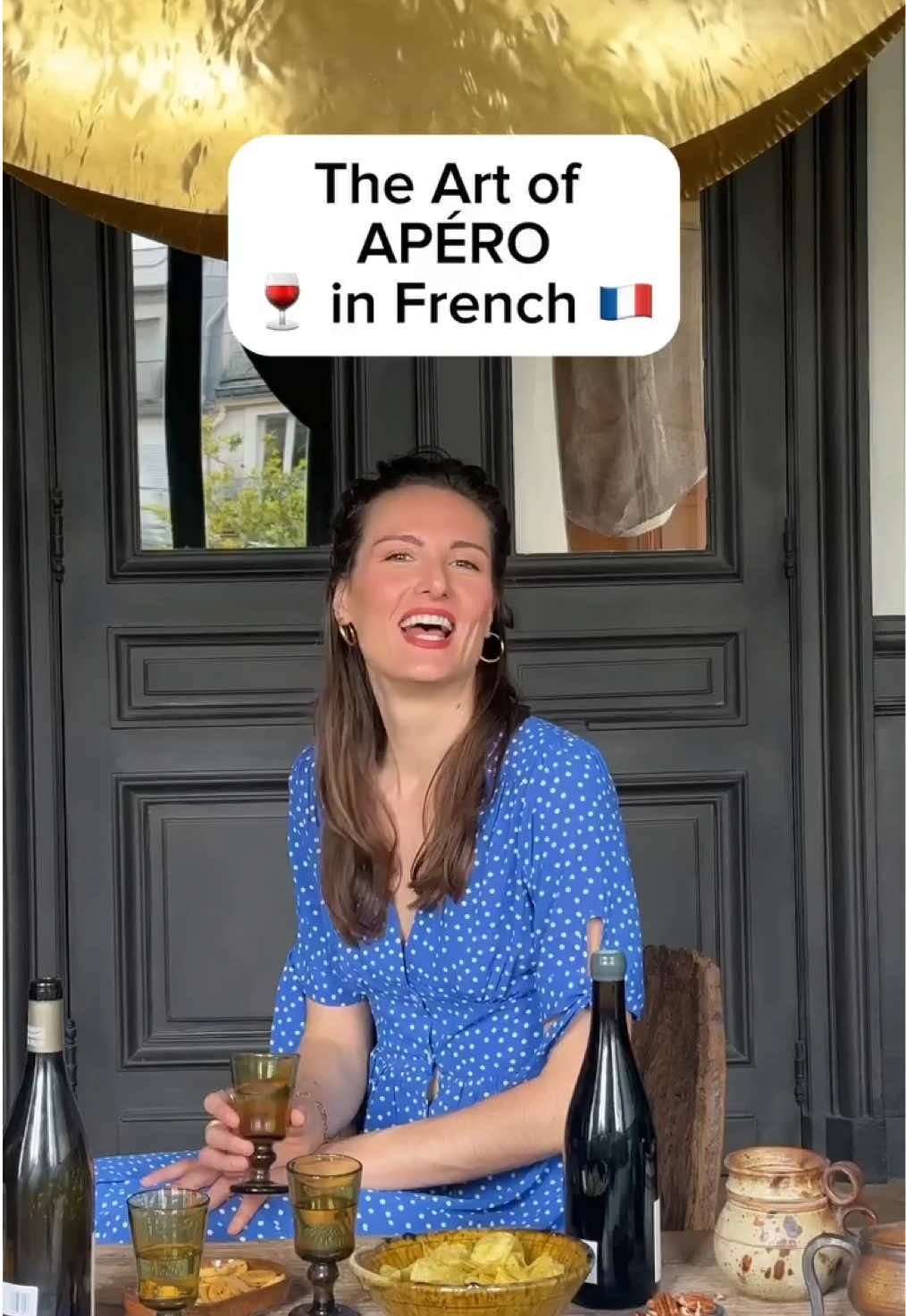 A post by @hellofrenchnyc on TikTok caption: The art of apéro à la française 🇫🇷🥖🍷 More than just snacks & sips, apéro is about ”l’art du partage”—sharing food and moments before dinner. Usually after 5pm, anywhere, any day! ✨ L’apéro = apéritif ✨ Grignoter = to snack ✨ Grignotage = the act of snacking 💬 Ever had an apéro? What French traditions are you curious about? 📚 Want to apéro like a Parisian? Grab my Paris Travel Guide via the link in bio! . . #apero #frenchculture #learnfrench #parisvibes #frenchlifestyle #paris #france #nyc