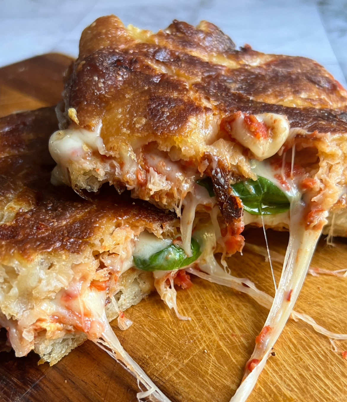 A post by @_lacebakes_ on TikTok caption: Who can resist a cheese pull on World Cheese Day?! LET’S GET CHEESY…leave your fave cheese pun or joke in the comments. I wonder who the funniest person will Brie?! 🧀 #worldcheeseday
