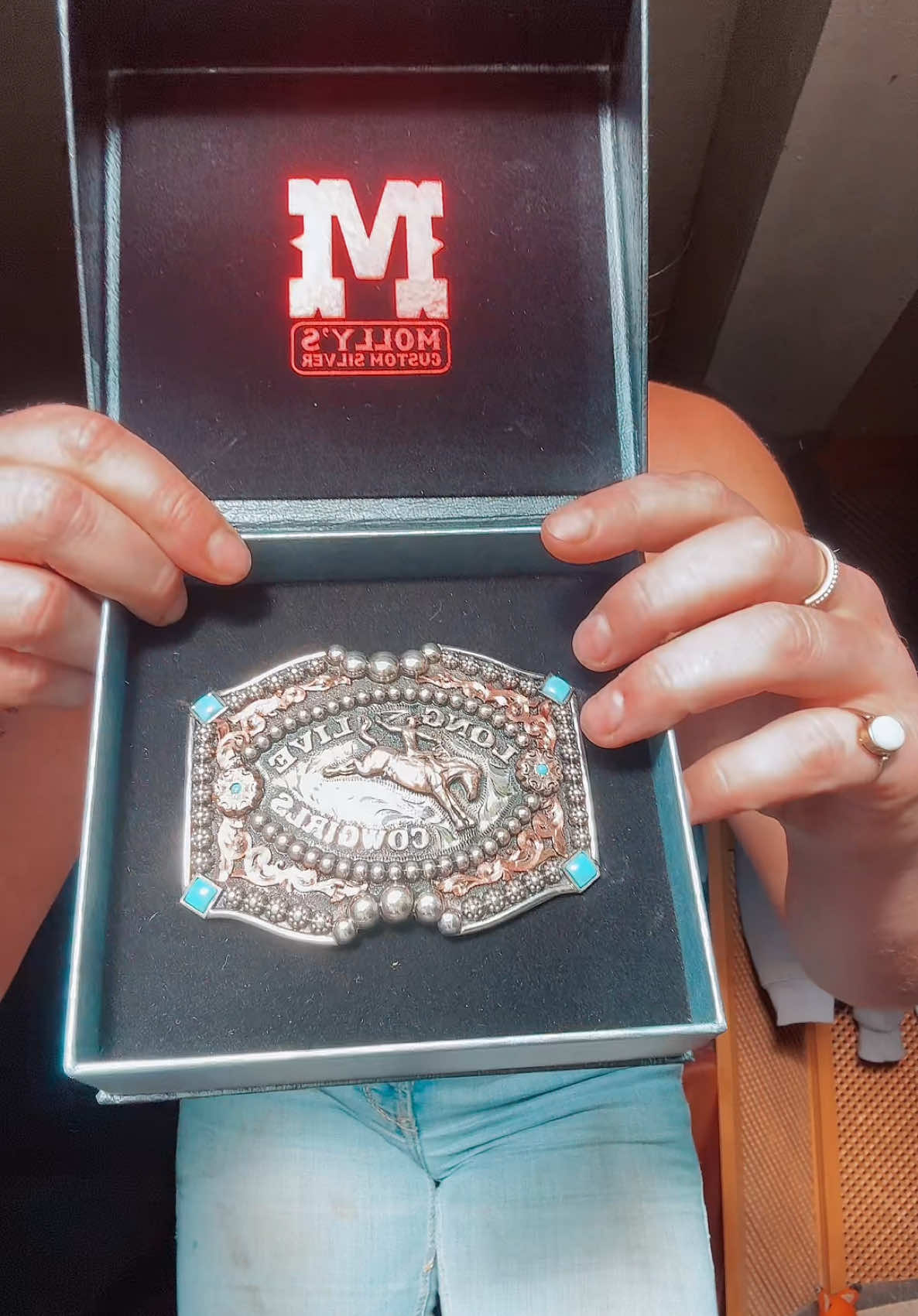 A post by @georginasammut4 on TikTok caption: Who’s ready for me to style it 😍?? I’m beyond grateful! Thank you @Molly's Custom Silver for the most beautiful, detailed all in all awesome buckle 😍 #buckle #belts #custom #gifted #fyp #cowgirl #grateful 