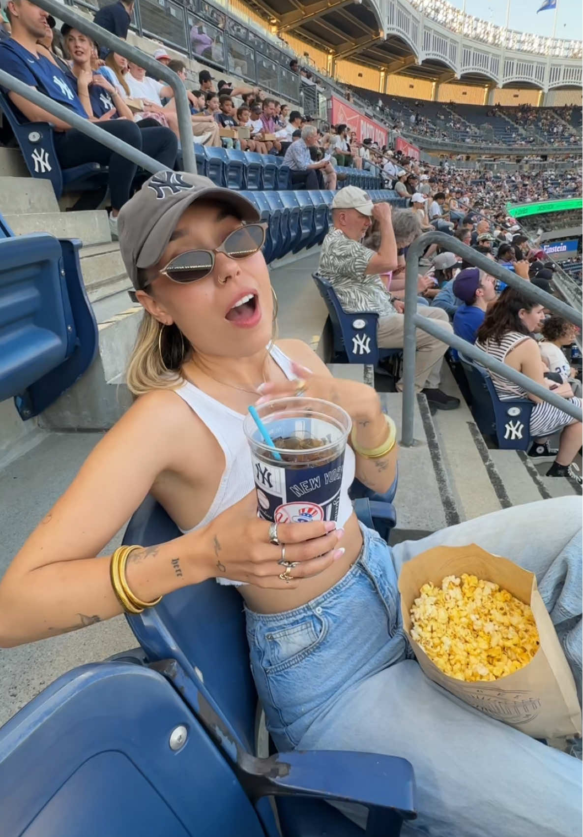 A post by @kristenmcatee on TikTok caption: here for the baseball butts & popcorn ⚾️🏟️ #yankees #baseball 