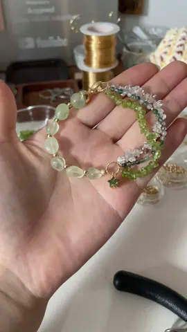 A post by @likayjewel_diylilylin on TikTok caption: Forest star bracelet made of prehnite, peridot, clear quartz and moss agate 🌳💚🌿🍀🌵🌱✨#bracelets #braceletmaking #handmadejewelry #braceletstacks #braceletlover #tutorial #braceletbusiness #foru #summer 