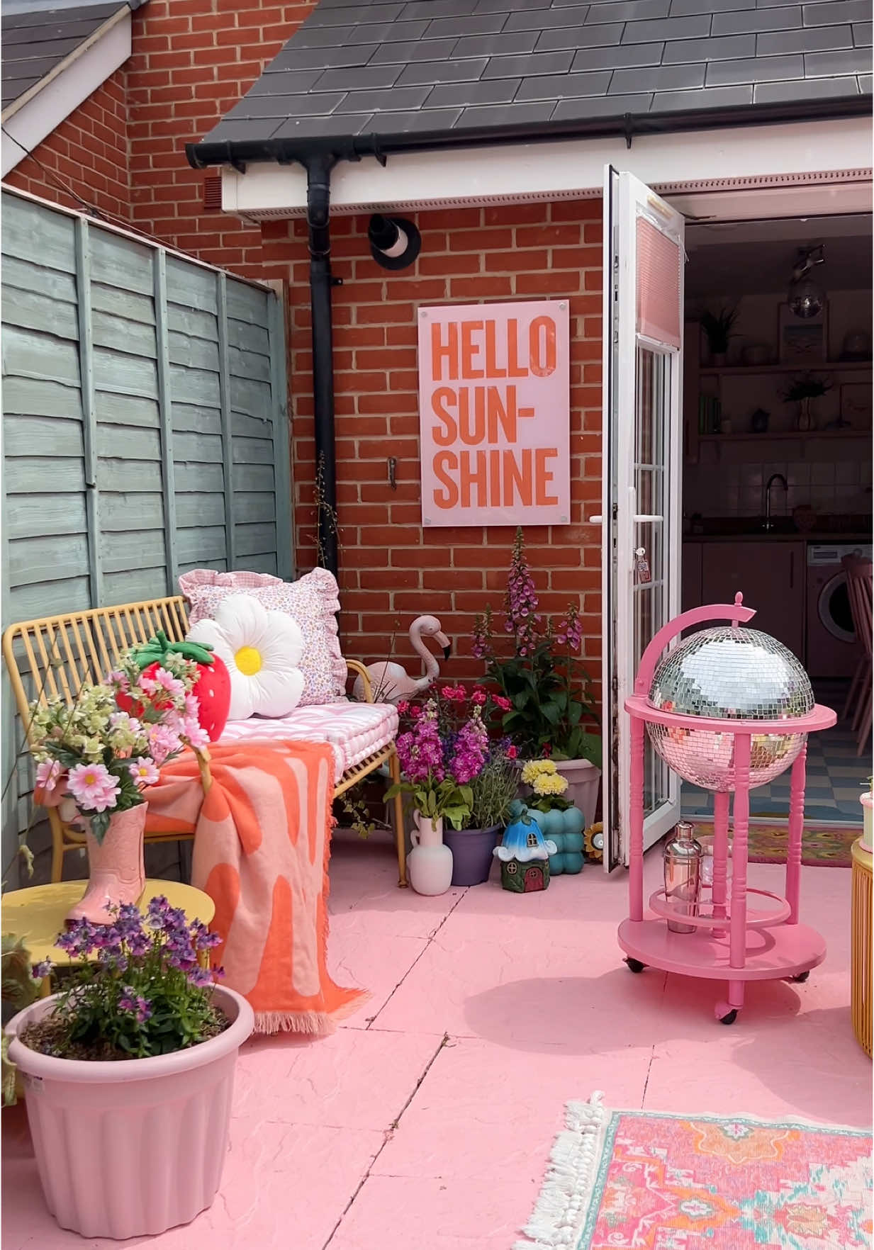 A post by @kate_rose_morgan on TikTok caption: Getting my garden summer ready! I always love giving my patio a fresh coat of pink paint 🌸 #patiomakeover #paintedpatio #gardenmakeover #patio #patiodecor #patiofurniture #gardenproject #diyproject #diyhomedecor #pinkgarden 
