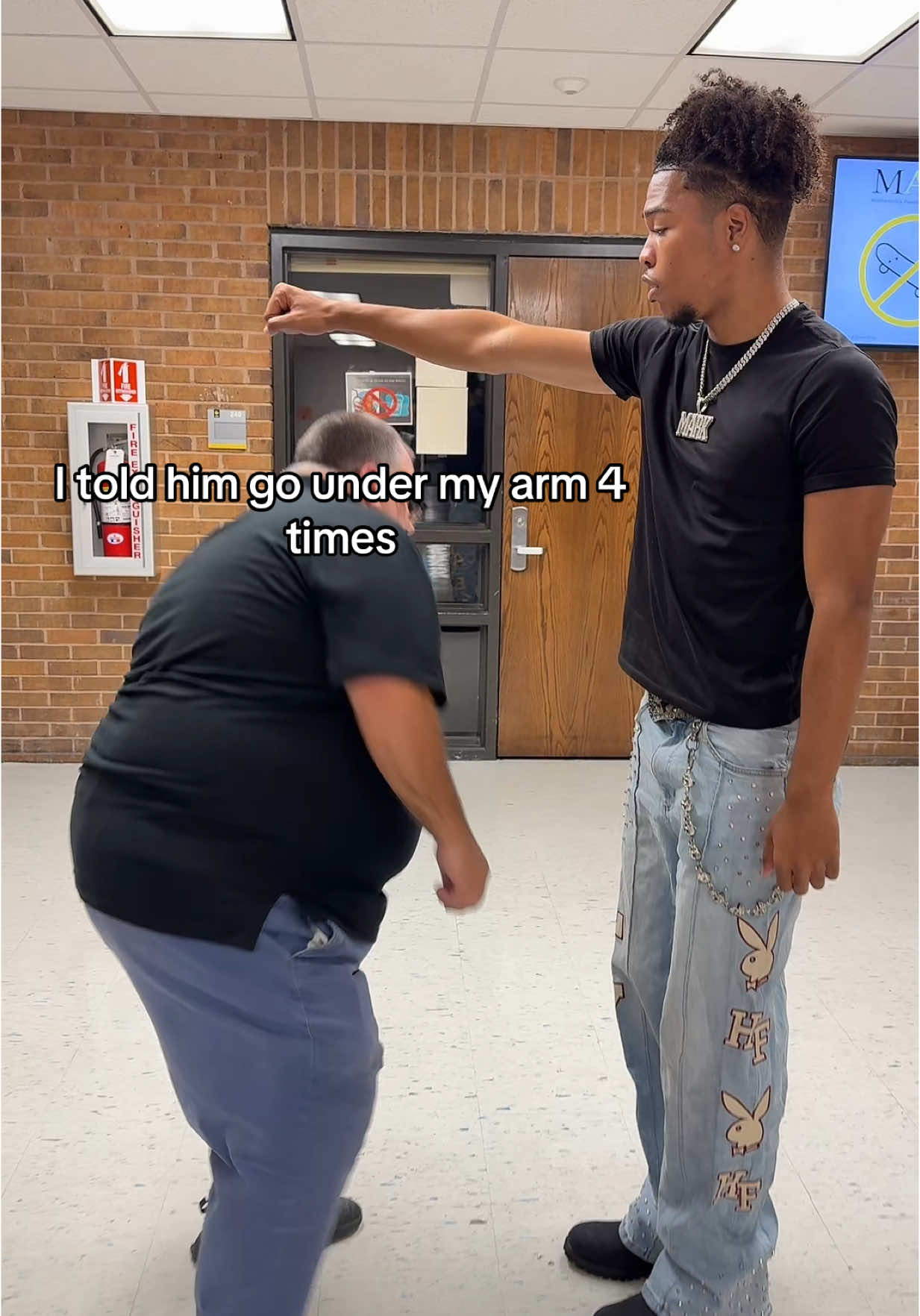 A post by @lilmark_m256 on TikTok caption: How I teach him a dance 😂😭 w / @urfaveteach407 ( follow my IG :lilmark_m )