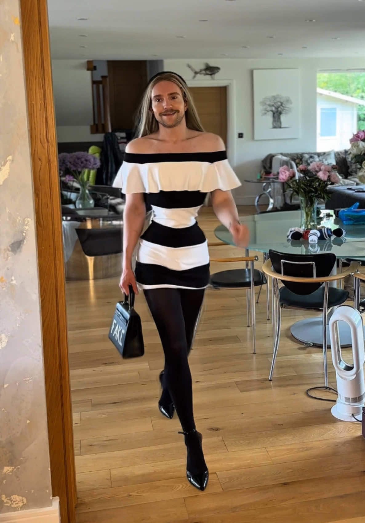 A post by @nicholas_flannery on TikTok caption: You don’t even wanna know how long it took to get the first fashions in line. That dress is 3/4 length as you can see by the funny thing I left in at the end. But I really did enjoy the black and white - also the shoes you can’t tell but they’re very Mariah Carey honey music video. think tom Ford when he was at Gucci. Very 90s inspired and super seductive. This scene is sort of giving Carrie Bradshaw on her birthday and since I’ve started working out my arms scream MAN so I feel the off the shoulder looks were fitting to disguise and bring the femininity back #jenniferaniston #katehudson #katherineheigl #50firstdates #satc 