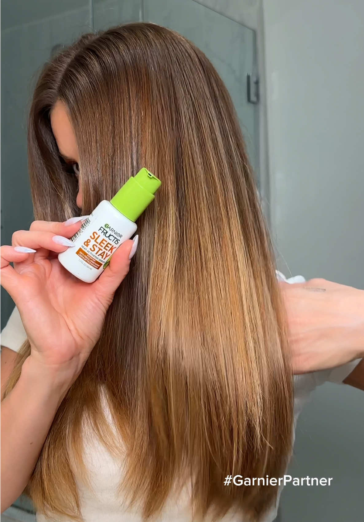 A post by @anggwells on TikTok caption: Glassy hair that won’t frizz up thanks to @GarnierUSA Fructis Sleek & Stay💚 #garnierpartner #glossyhair #garniersleek #garnierhaircare 