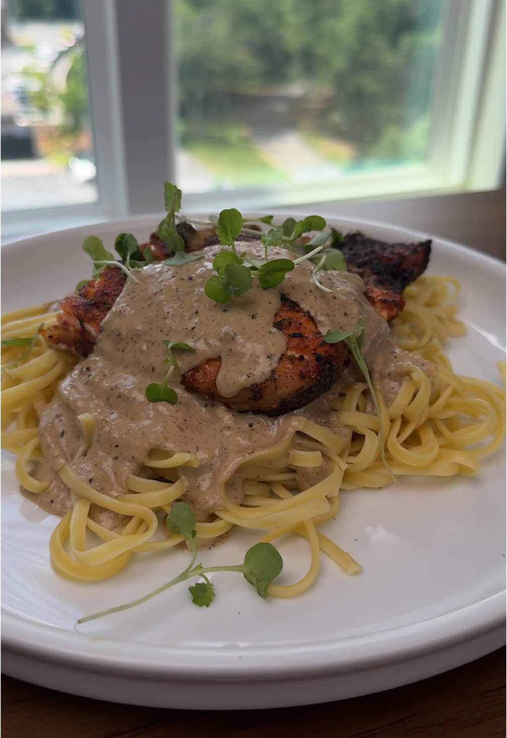A post by @chefchosen on TikTok caption: Summertime means the kids are home and the kitchen stays busy—this baked salmon with jerk cream sauce is one of those easy wins. Flavorful, fast, and guaranteed to make ’em quiet at the table for a few minutes 😮‍💨🔥 Bake salmon at 400 degrees F , for 25-35 minutes depending on your desired donness. 