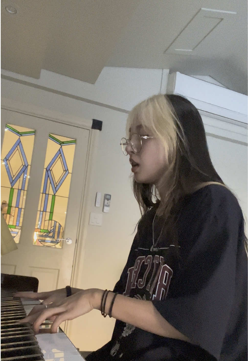 A post by @hannahbahng on TikTok caption: #draft from when i was playing what never lived back home in sydney on my piano (feat @Jessica Bahng in da back)