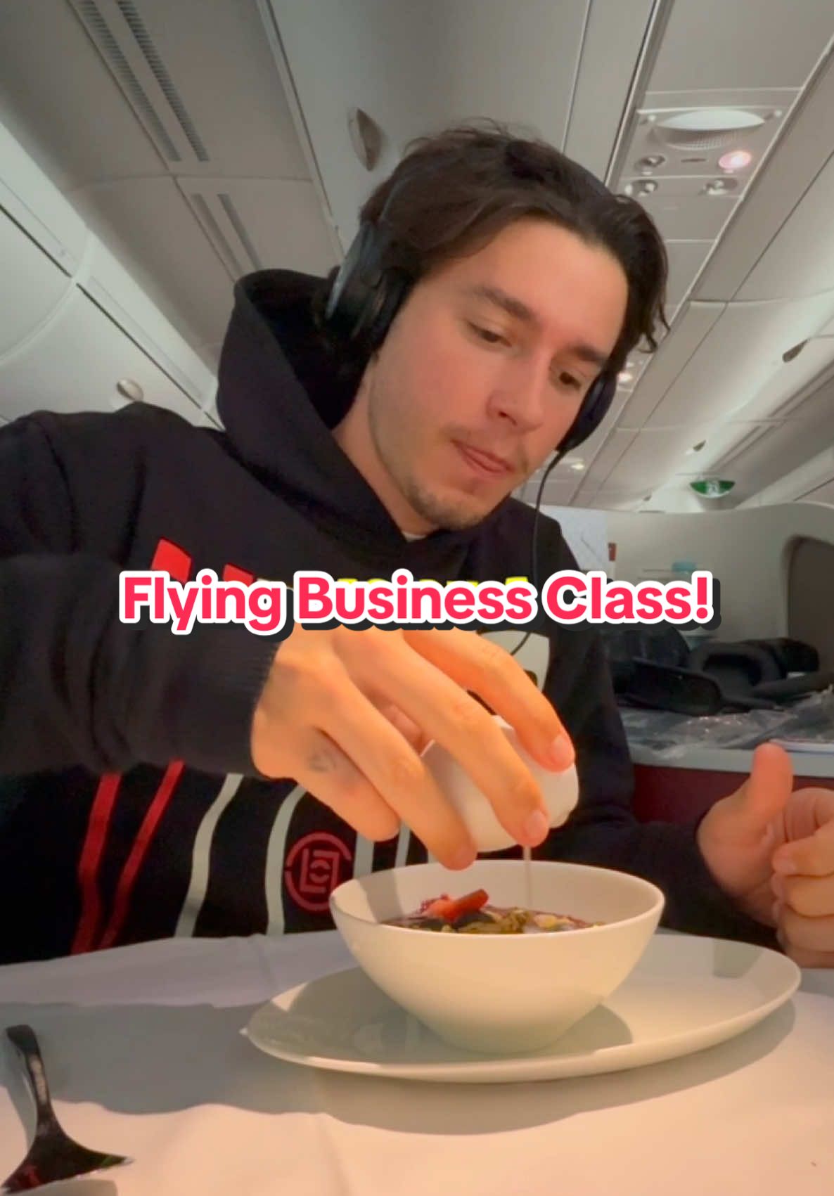 A post by @tom on TikTok caption: Would You Fly Business Class? 😳 @Qatar Airways #qatarairways #businessclass #a380 #doha #hamadinternationalairport 