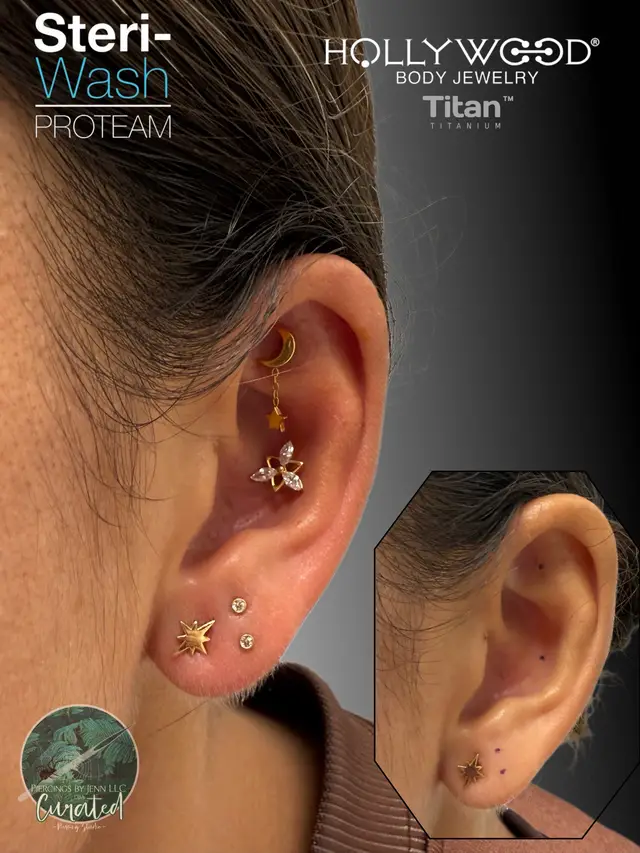 A post by @piercingsbyjenn on TikTok caption: My amazing client let me curate and design her ears a bit. She had these super cute North Star in her first lobes and that let us to our inspirations….. So we did a stunning faux room/flat with a moon & star dangle. The Conch is a beautiful Marquis Star piece and then we added a set of stacked lobes. Everything is pierced with traditional ASTM F-136 Implant Grade Titanium posts(silver), the tops are ASTM F-136 PVD Gold Titanium threadless pieces.  All pieces from @HBJUS….already planning on adding a space ship and rocket, and little alien guy!! 💦aftercare always provided from @Steri-Wash PAC #steriwashproteam #steriwash 💦 #piercingshop #piercings #piercing #piercingsoftiktok #pierced #fyp #fypage #piercingstudio #safepiercing #bodypiercer #bodypiercerlife #bodymod #professionalpiercer #fypシ #curatedear  Located in Murrieta CA @SolaTemeculaMurrieta at my studio Curated…@Sola Salons  📆book today at the link www.piercingsbyjenn.com